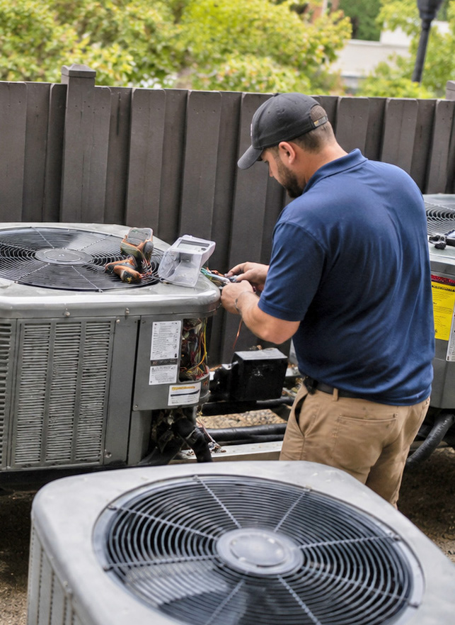 HVAC technician working on heat pump